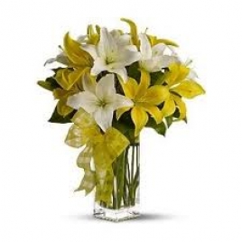 Exotic White And Yellow Lilies In A Glass Vase
